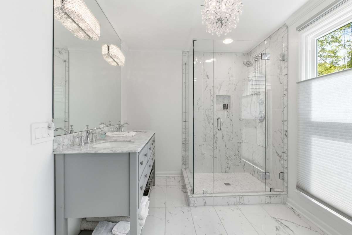 This is the downstairs full bathroom. It features a double vanity, huge walk-in shower and great light fixtures.