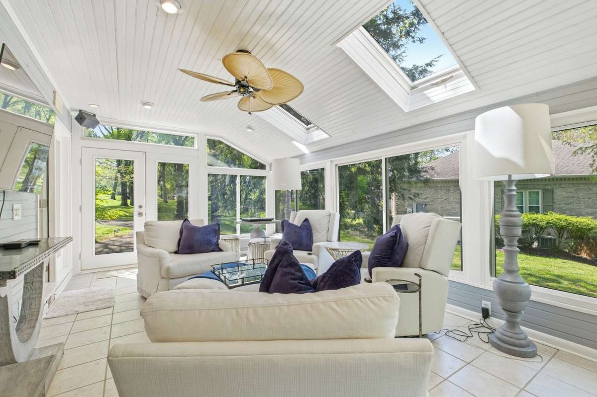 The sunroom is a great place to relax. It features tile floors, beautiful large windows and a skylight.
