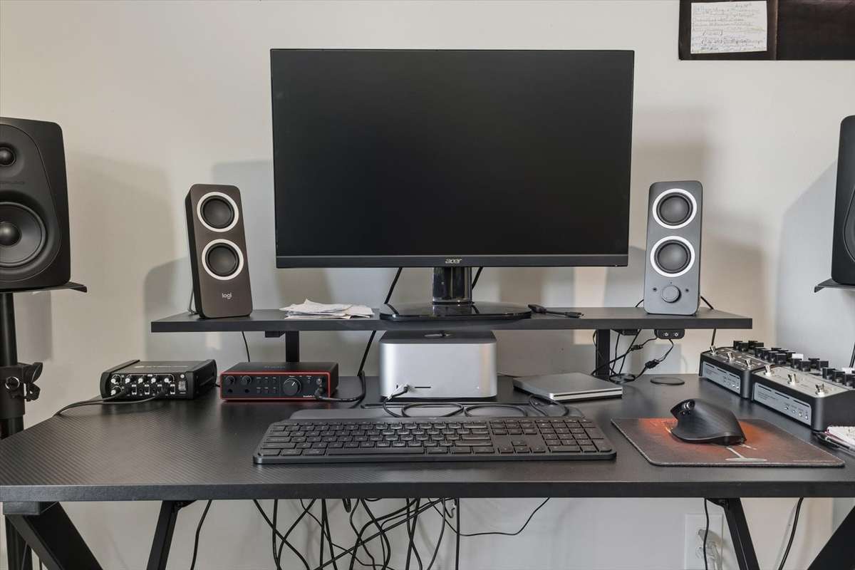 Get all of your recording done here with multiple sets of speakers. Mac Pro, Guitar and Bass Amp modeling pedals.