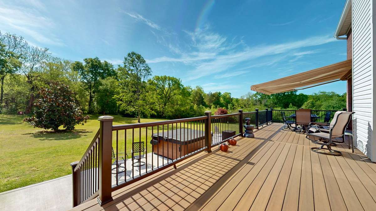 Backyard retreat!  Composite decking and aluminum handrails make this space easy to maintain and gives you more time to relax!  Retractable awing with remote.  **Hot tub does not convey.**