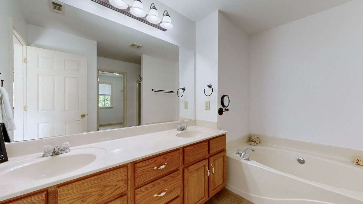 Primary bath with soaking tub, double vanities, separate shower, and huge walk-in closet.