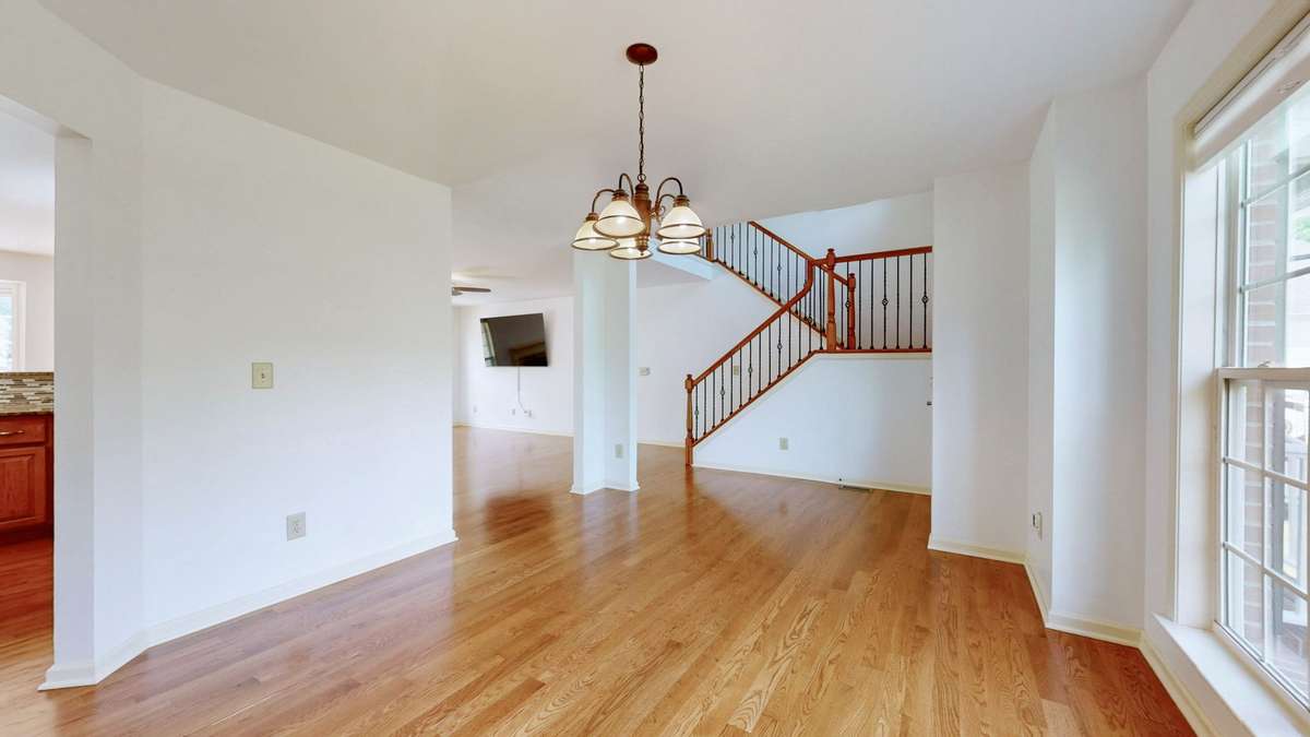 Hardwood floors just refinished!  Open and airy entry. Check out the beautiful oak and wrought iron handrail.