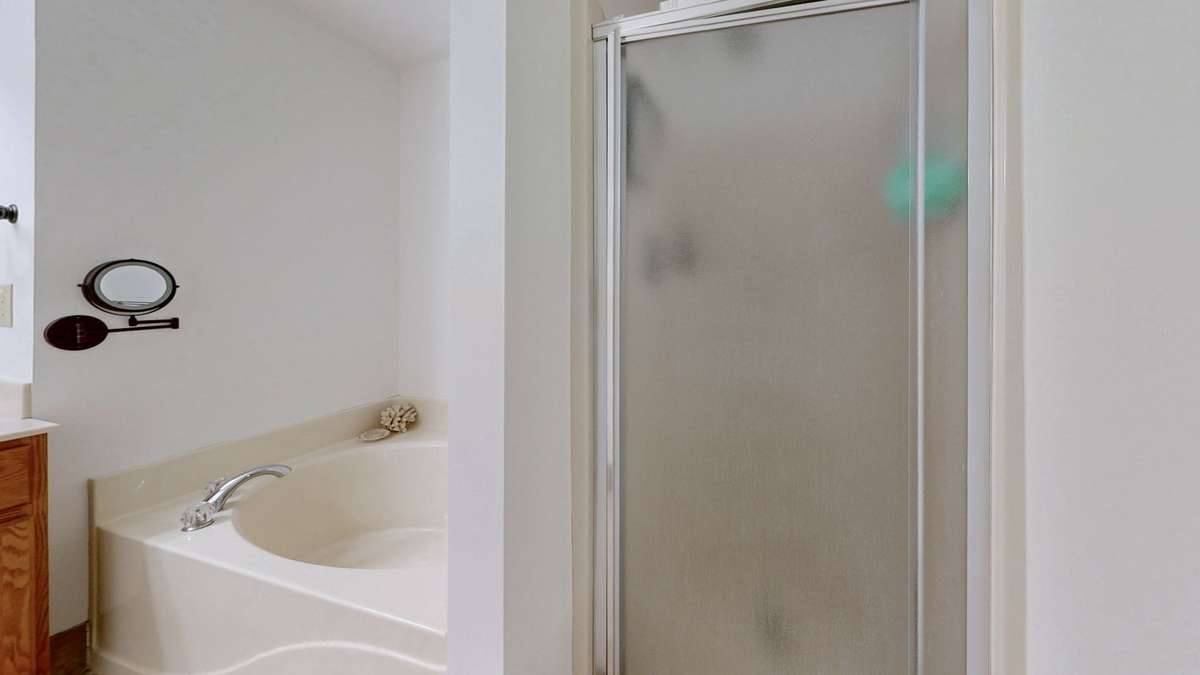 Primary bath with soaking tub, double vanities, separate shower, and huge walk-in closet.