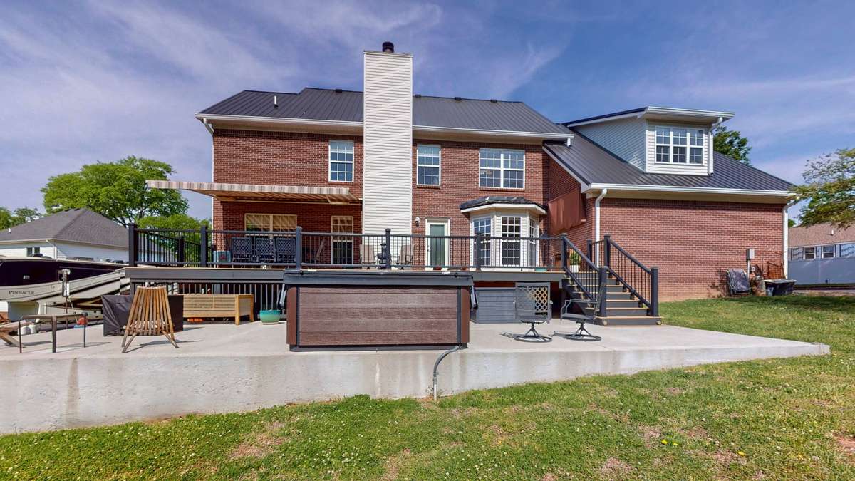 Backyard retreat!  Composite decking and aluminum handrails make this space easy to maintain and gives you more time to relax!  Retractable awing with remote.  **Hot tub does not convey.**