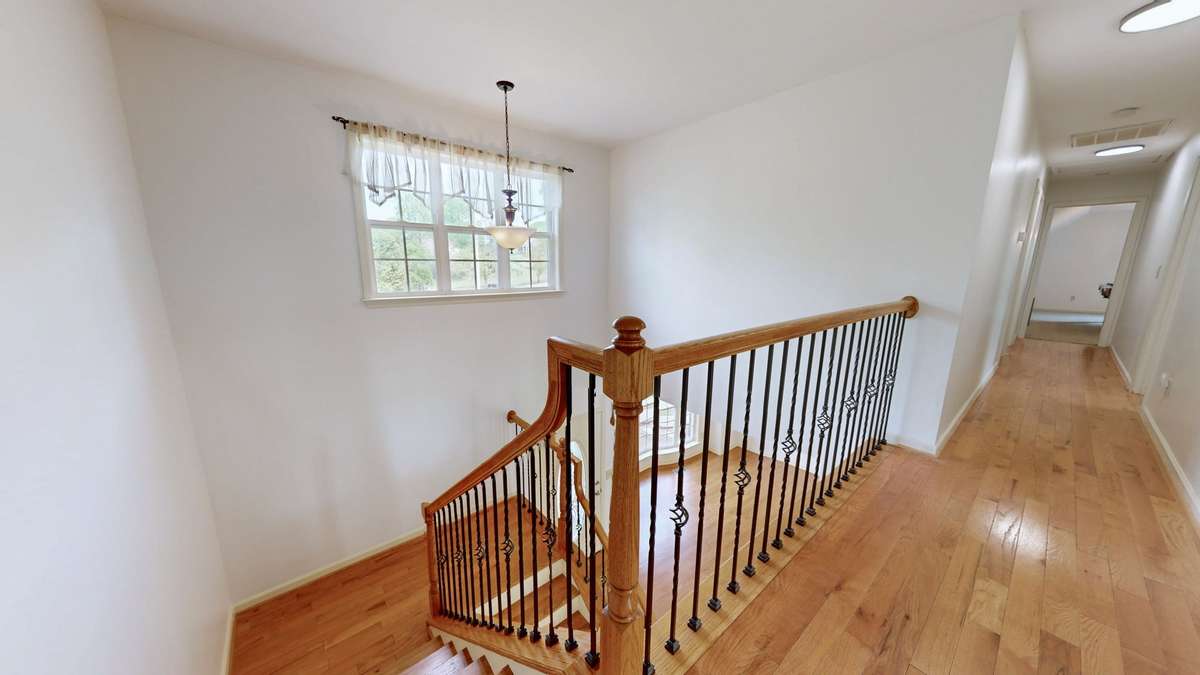 Gorgeous hardwood floors in second level hallway.