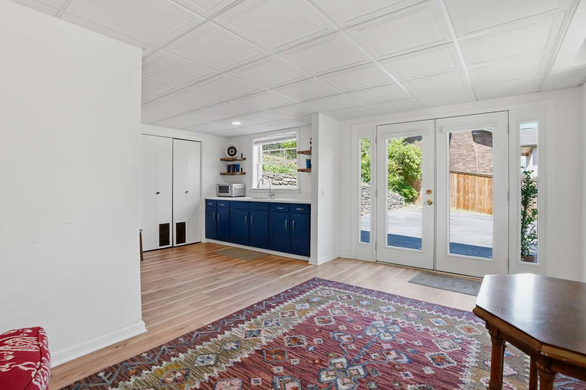 Separate basement entrance opens to kitchenette/basement living room.