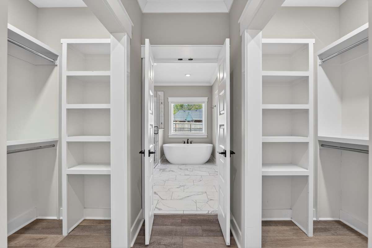primary suite closets with built in shelving