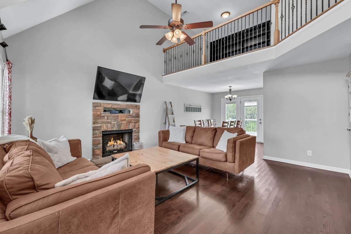 The living room features hardwood + gas fireplace.