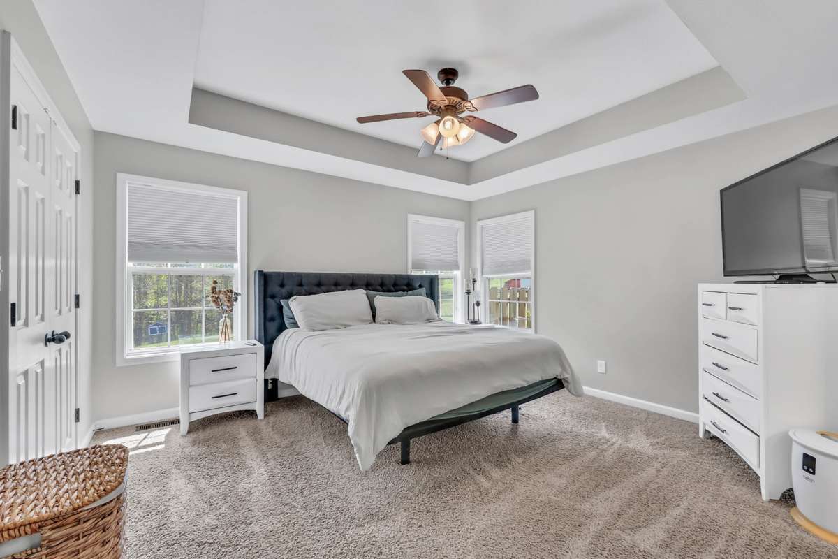 The primary suite features a tray ceiling + walk in closet + full bathroom.