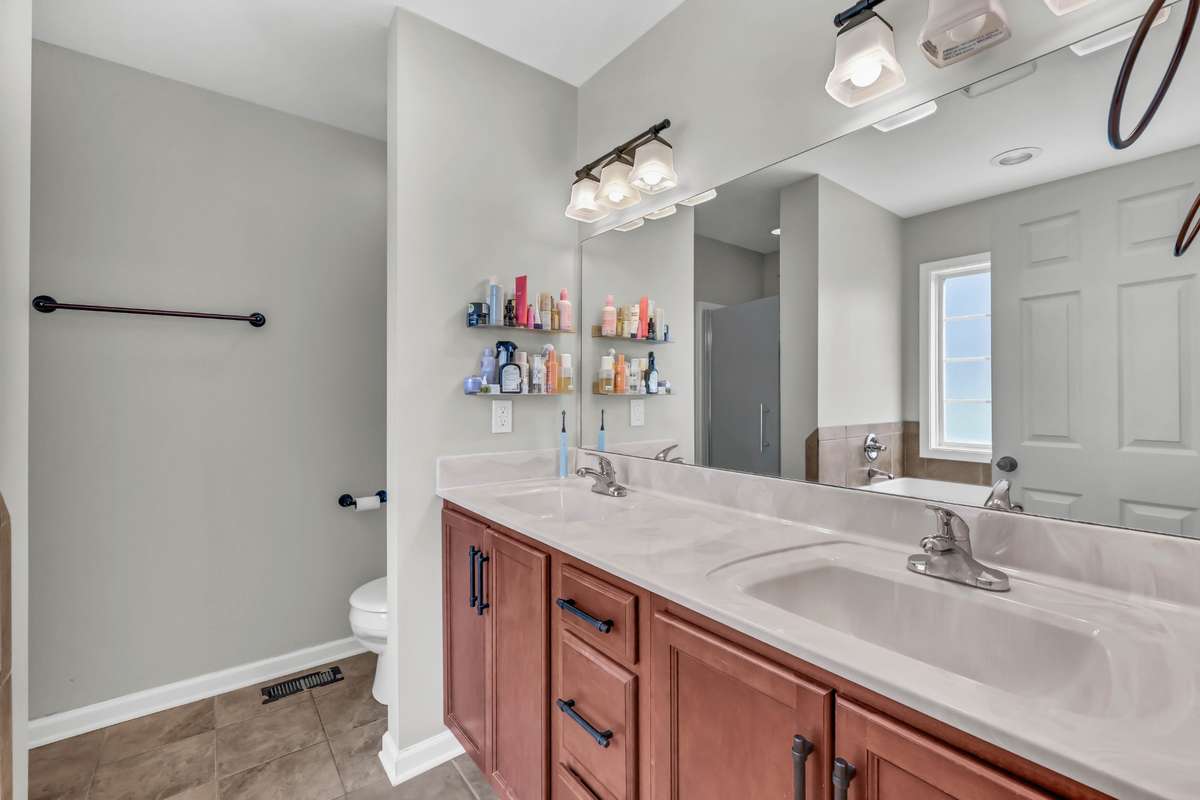 Primary bath includes double vanities + tile flooring.