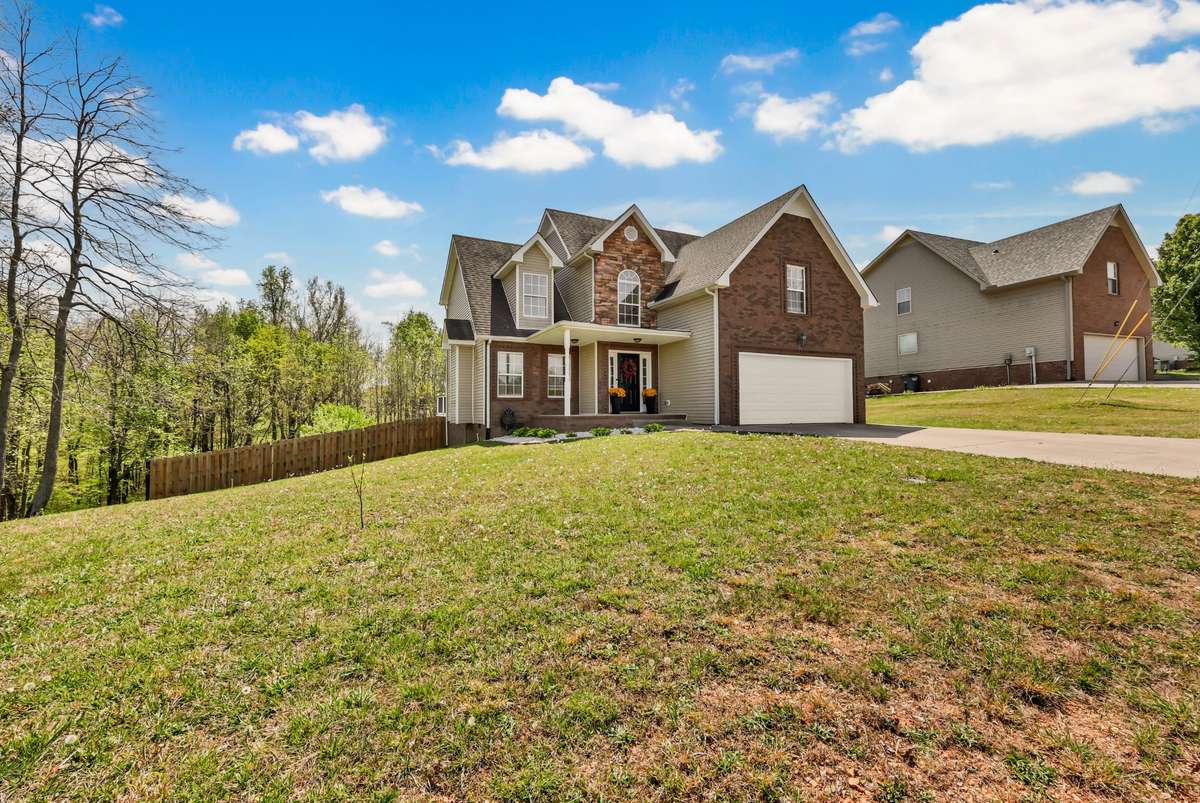 Covered porch, large lot, no HOA, & no backyard neighbors!