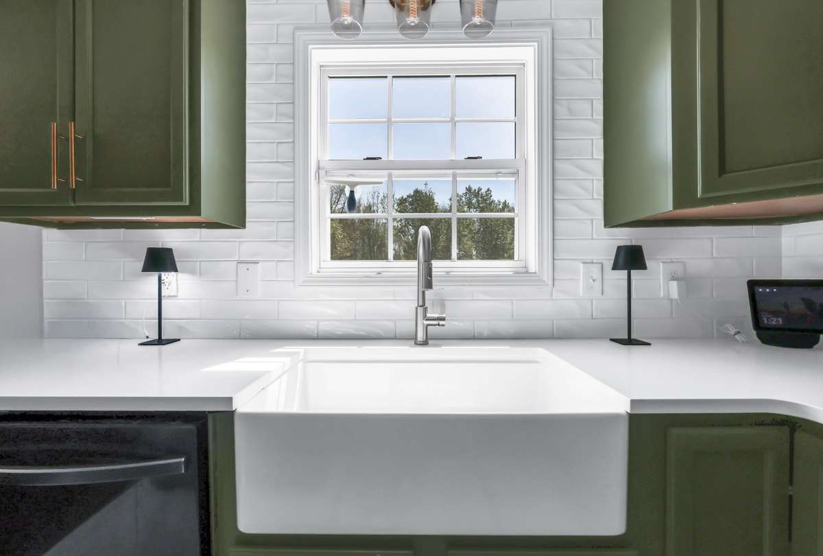 Bright + white tile backsplash & a farmhouse sink with a view!