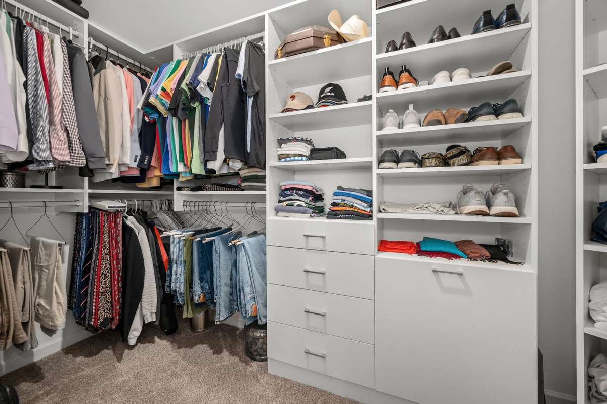 Plenty of space in this walk-in closet with built-ins!