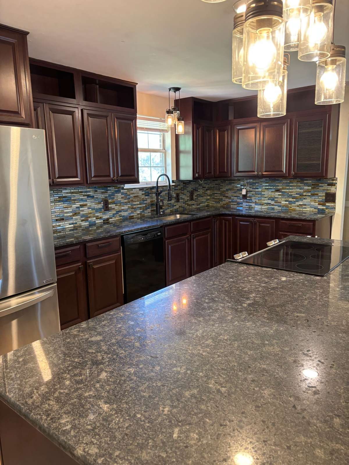 Updated kitchen with tiled backsplash and huge island.  So much storage.