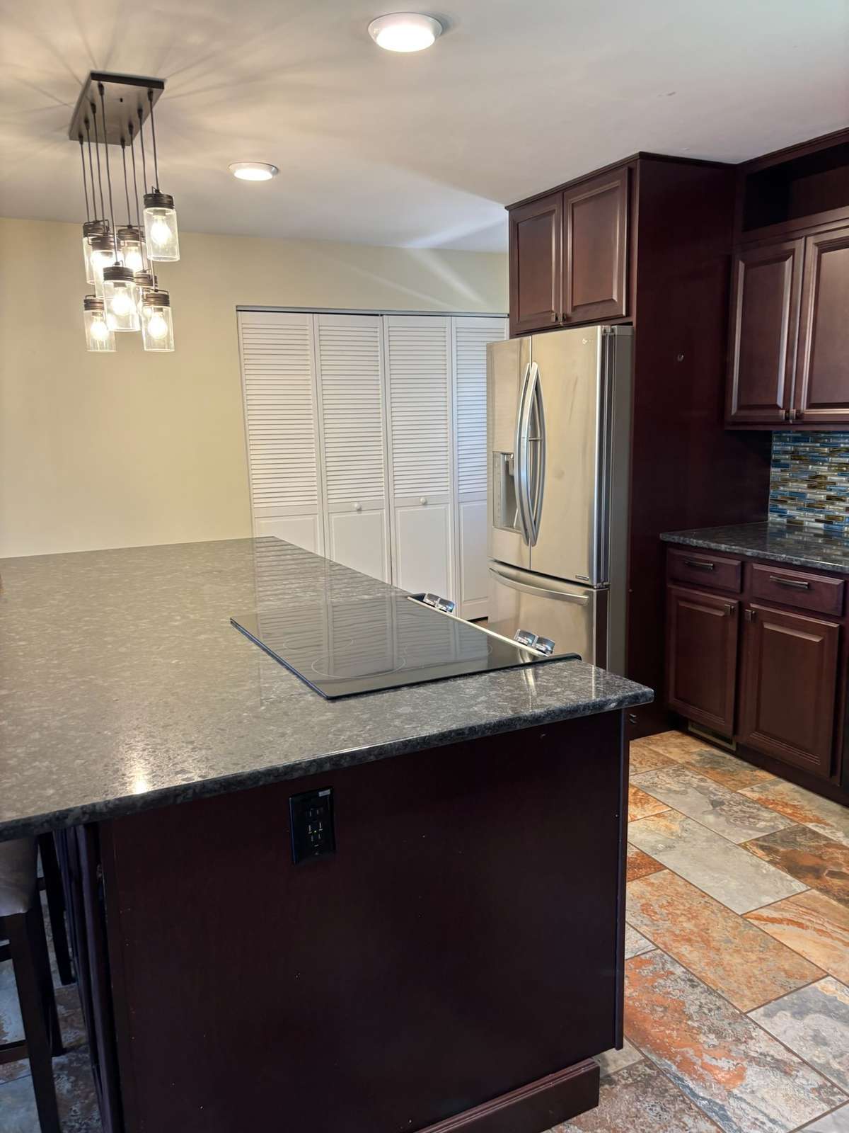 Large pantry at end of kitchen.  Beautiful tile floor. Custom cabinets/