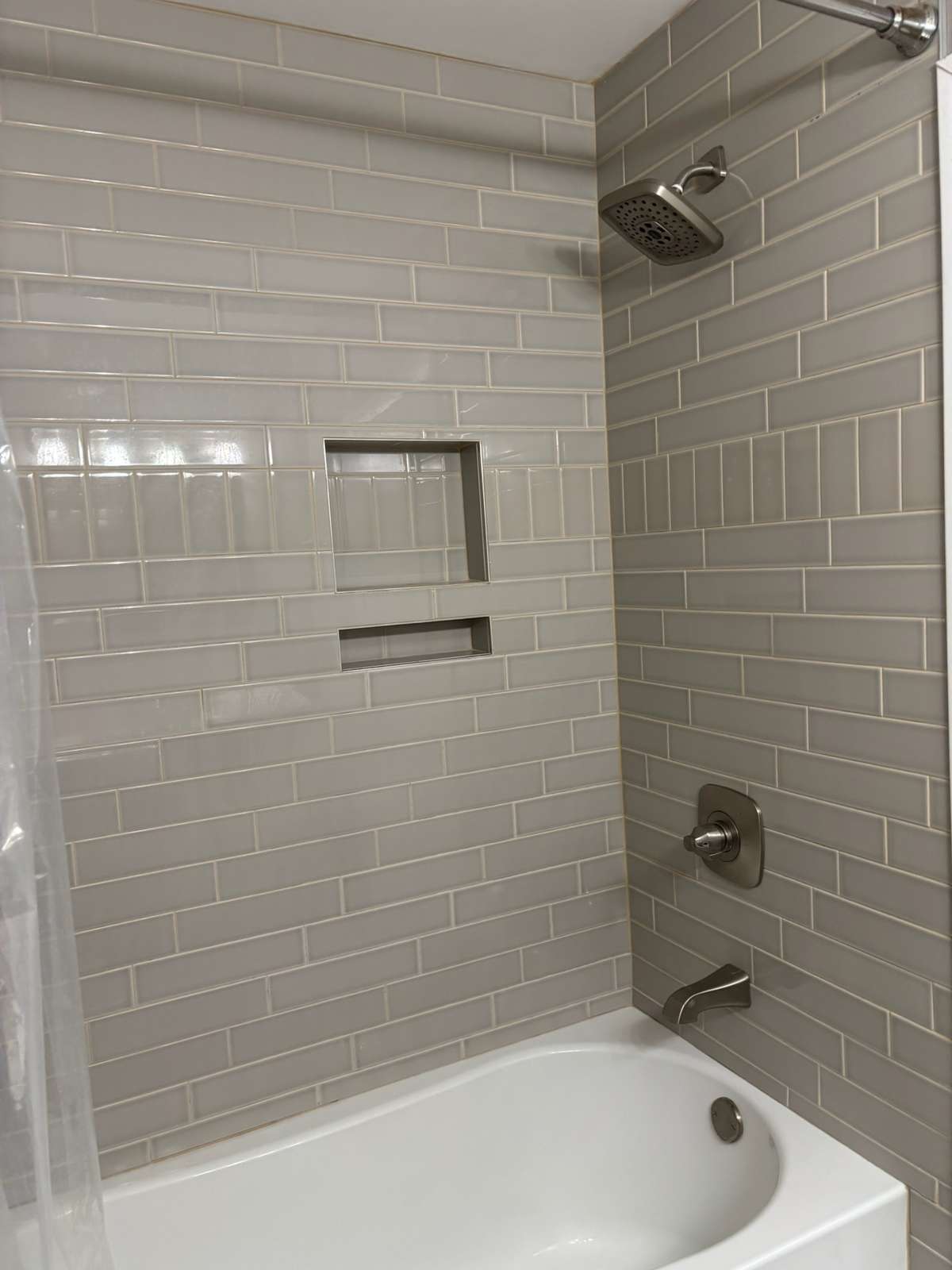 Tiled tub surround in hall bath.