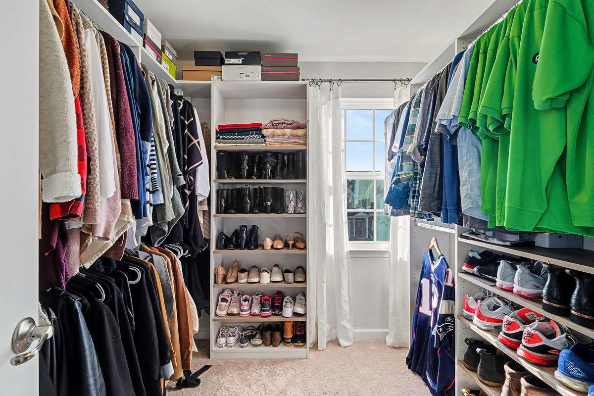 walk in closet with custom closet system and a window!