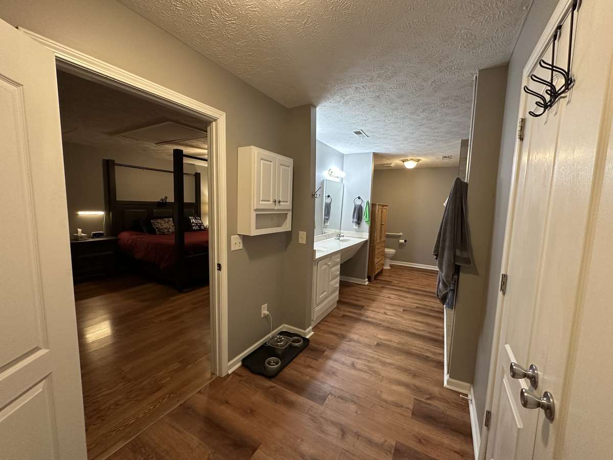Downstairs primary bath with double closets and extra large shower