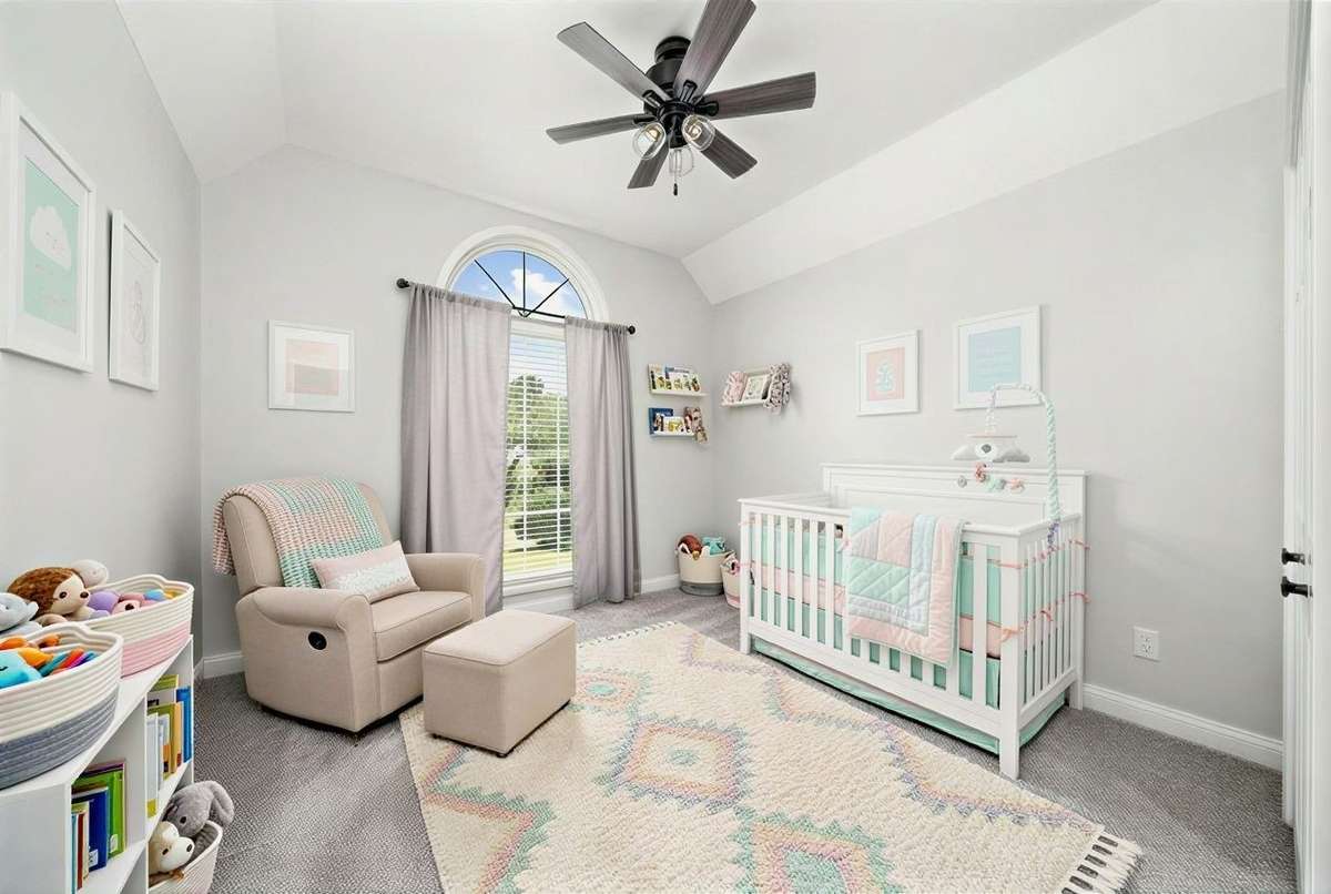 Digitally staged as a nursery option for this bonus bedroom space in the garage