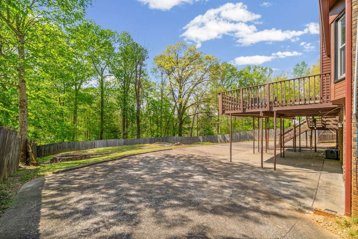 Your Back Yard with Concrete Covered Patio and Large Driveway leading to the Backyard Open Space