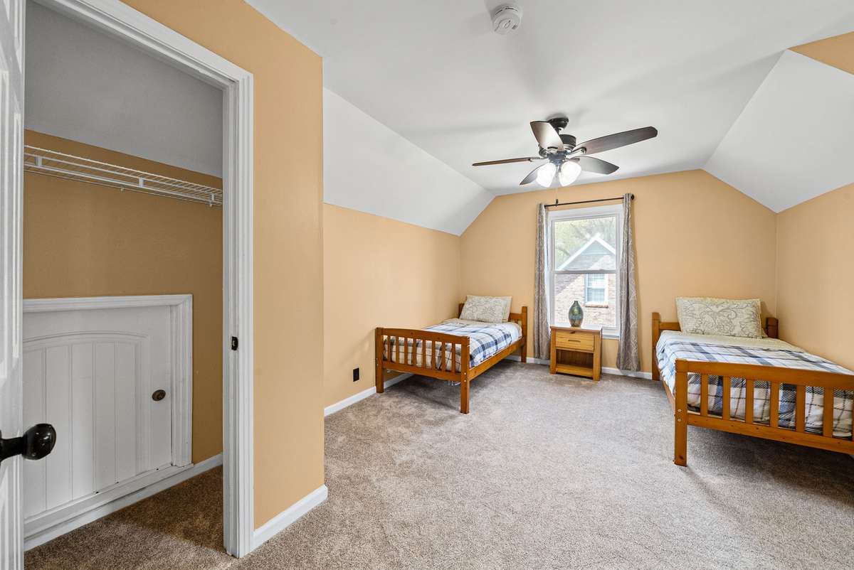 2nd Upstairs Spacious Guest Bedroom. Attic access in the closet for additional storage upstairs.