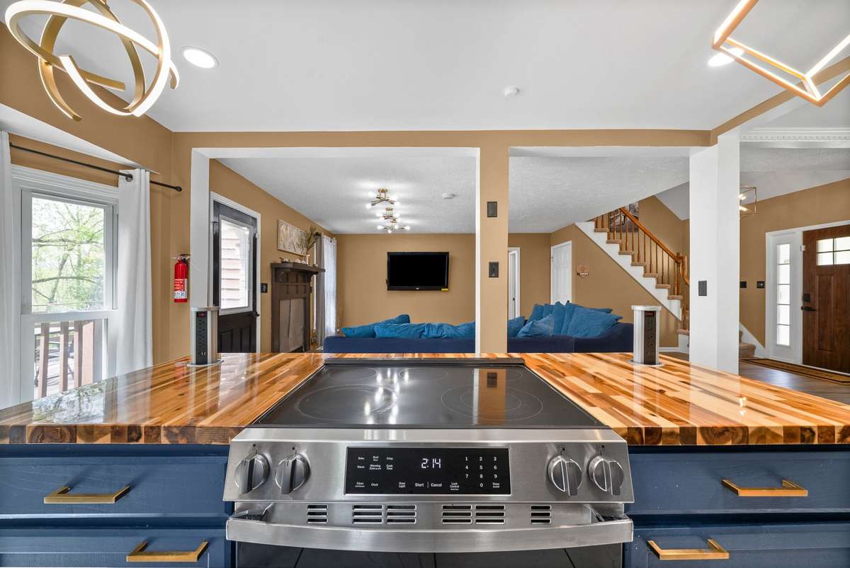 Smooth Top Stainless Steel Cook Top with Wooden Cutting Board Style Countertops