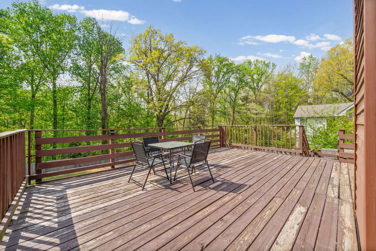 XX LARGE BACKYARD DECK, enter from upstairs kitchen. Stairway to go downstairs to the backyard.
