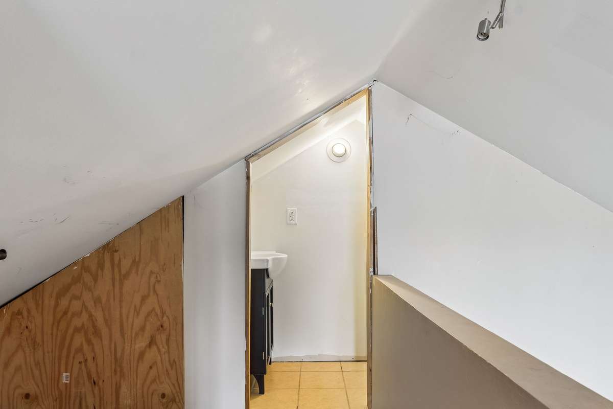 Another view in Attic Expansion area with view of partially finished 1/2 bath.