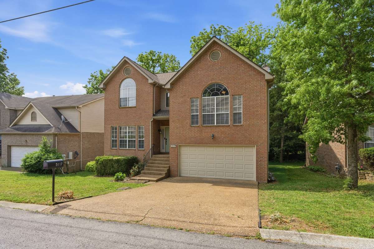 Beautiful brick two-story home with timeless curb appeal, oversized windows, and a welcoming front entry.