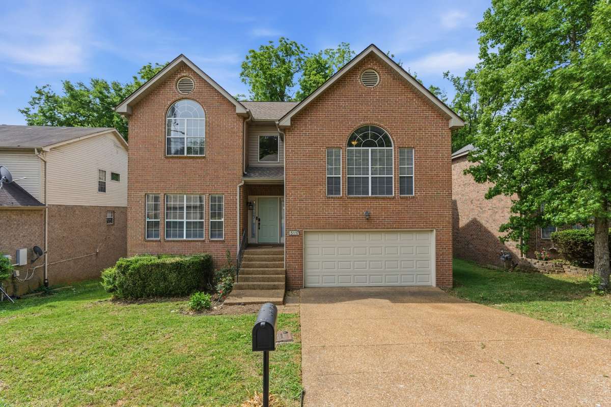 Beautiful brick two-story home with timeless curb appeal, oversized windows, and a welcoming front entry.