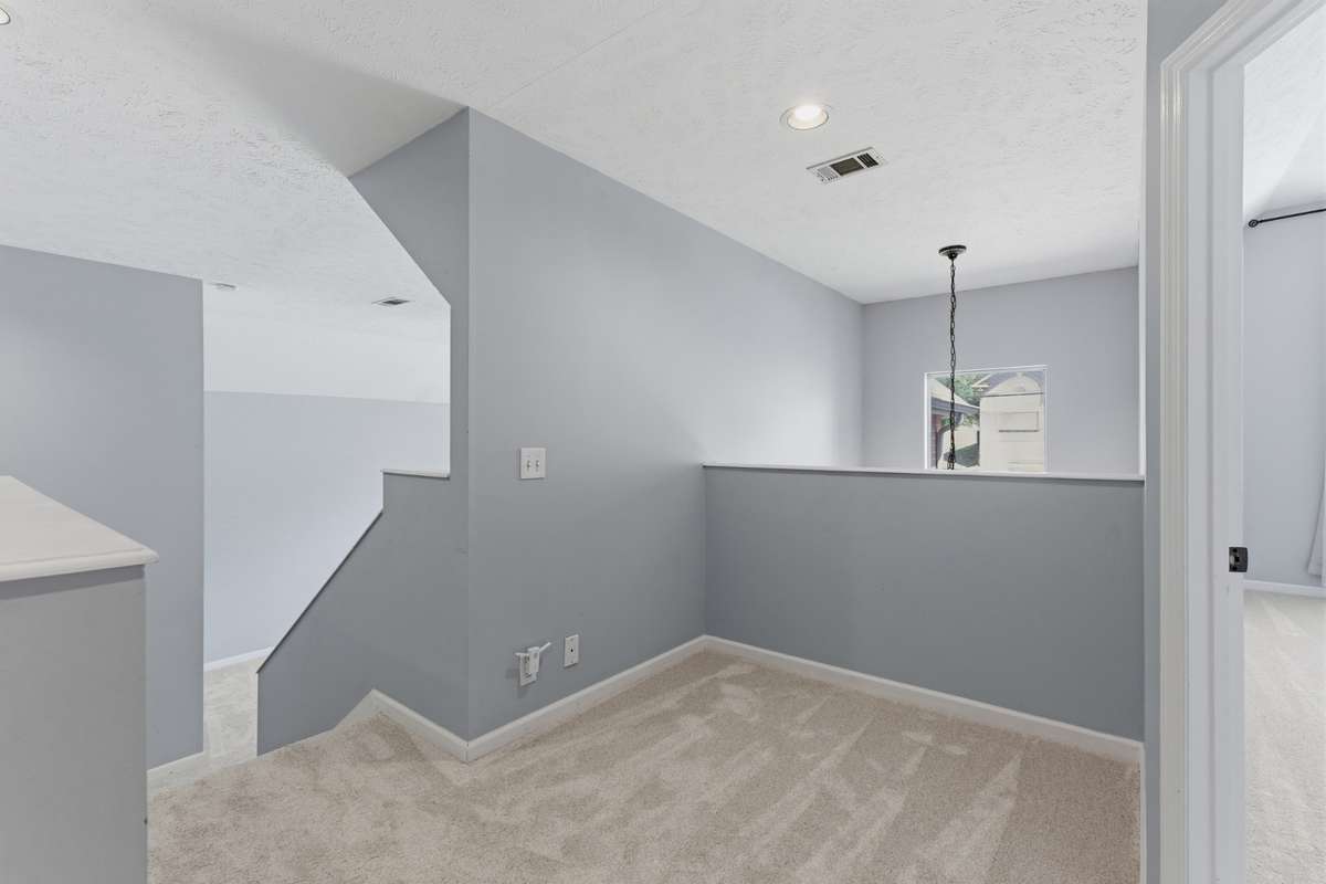 Landing space where the main, two additional bedrooms, laundry room and two full bathrooms are located.