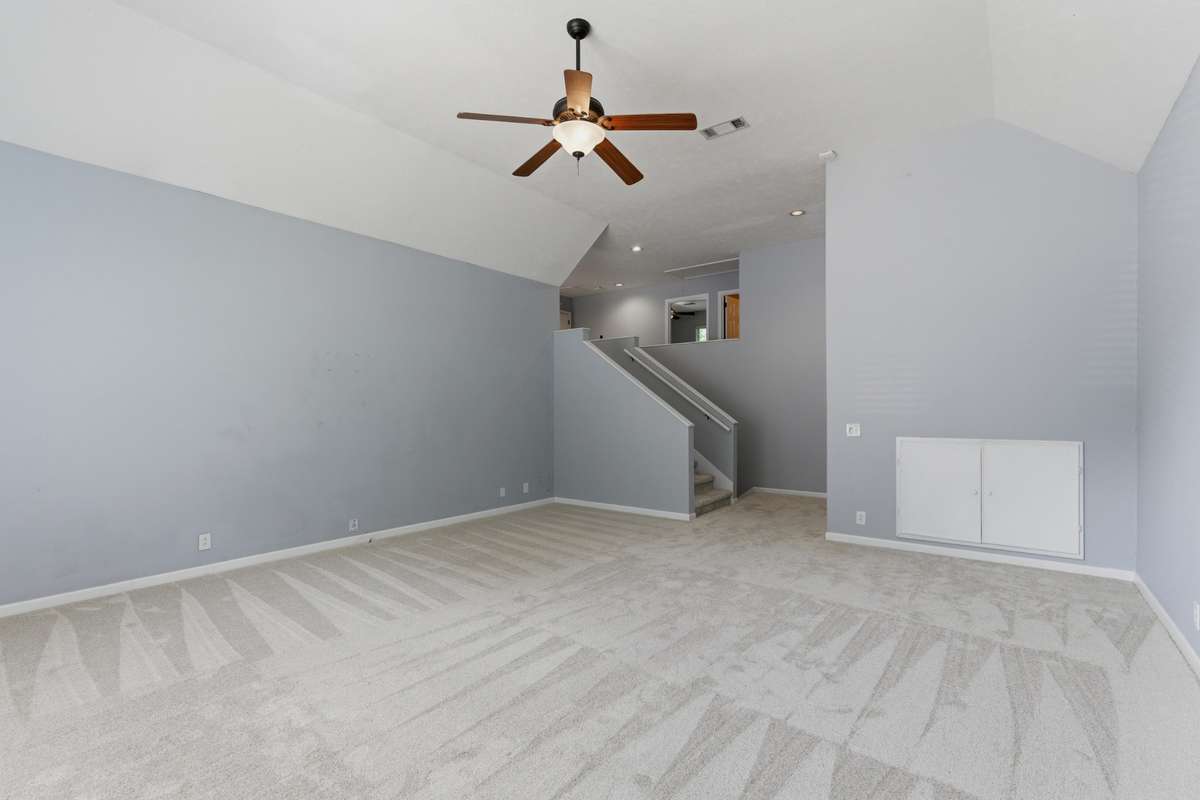 Massive bonus room with vaulted ceilings, oversized arched windows, and abundant natural light. Plush new carpet and flexible layout make this an ideal media room, playroom, or second living space.