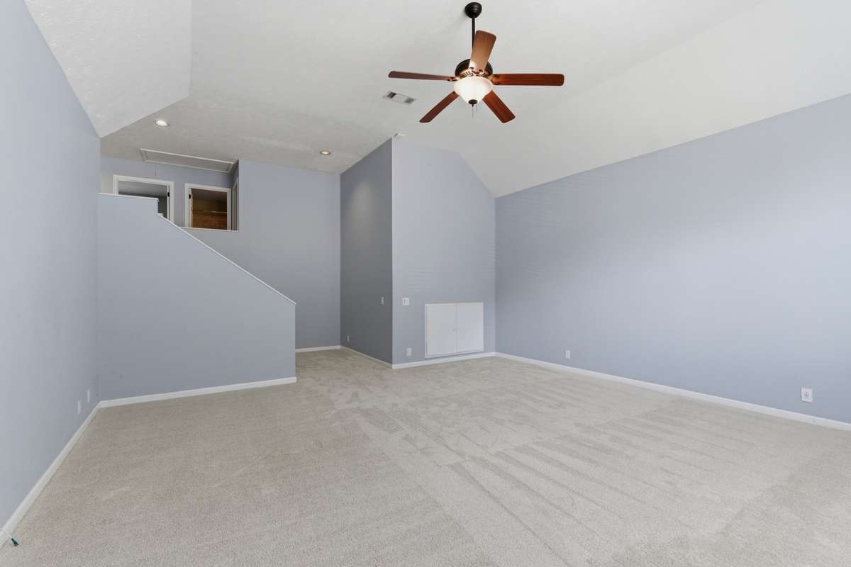 Massive bonus room with vaulted ceilings, oversized arched windows, and abundant natural light. Plush new carpet and flexible layout make this an ideal media room, playroom, or second living space.