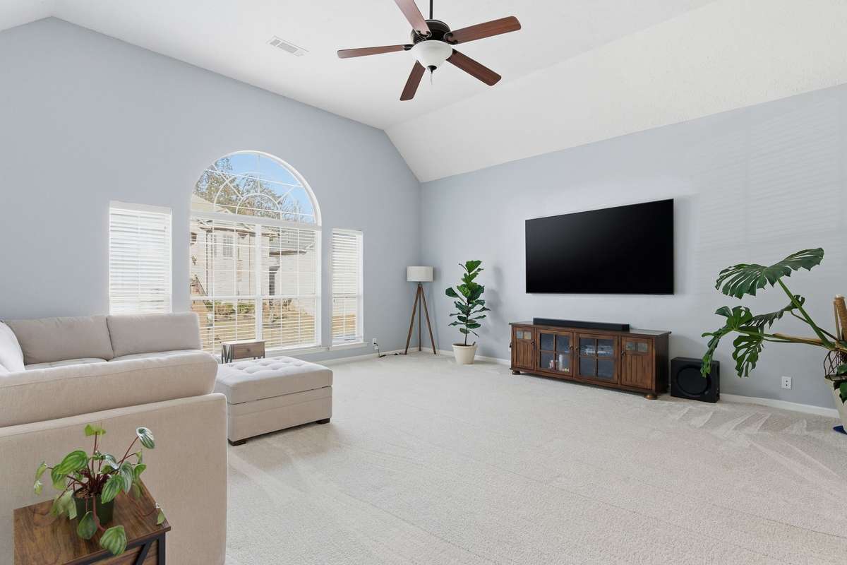 Massive bonus room with vaulted ceilings, oversized arched windows, and abundant natural light. Plush new carpet and flexible layout make this an ideal media room, playroom, or second living space.