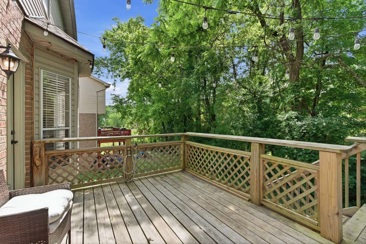 Private two-level back deck offering a comfortable, usable outdoor space—ideal for relaxing, entertaining, or enjoying quiet moments surrounded by mature greenery.