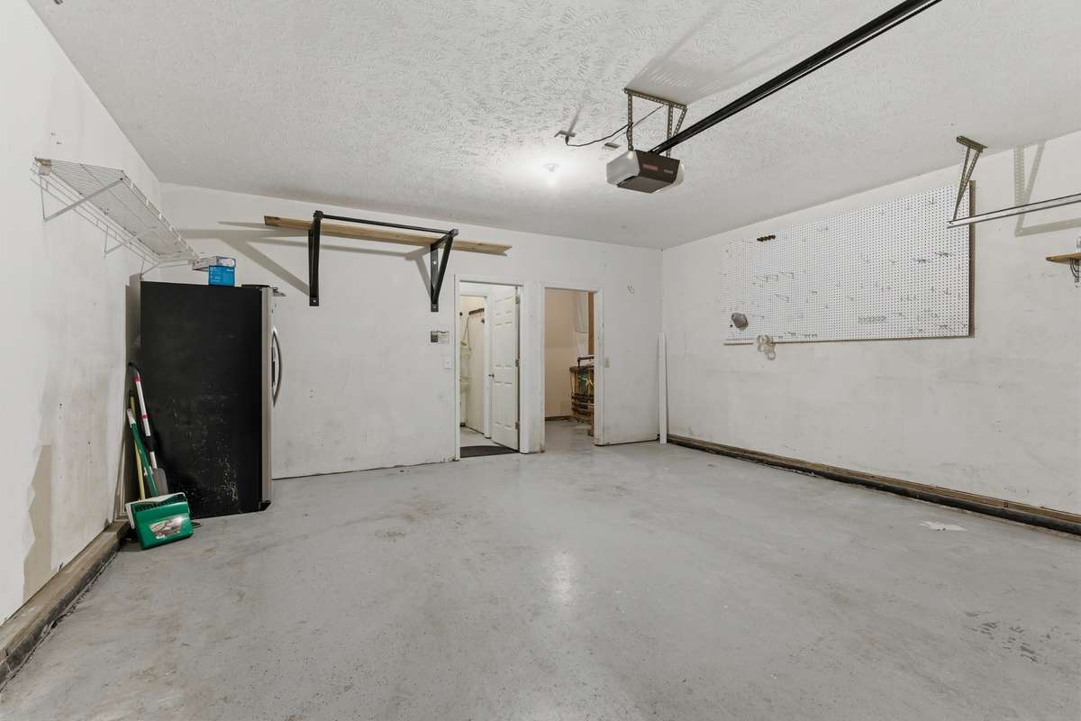 Two car garage with additional storage spaces