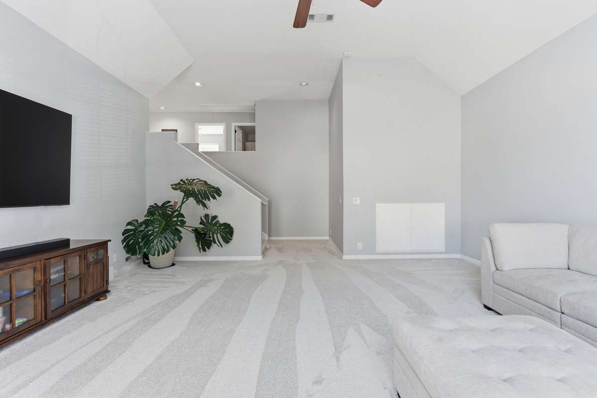 Massive bonus room with vaulted ceilings, oversized arched windows, and abundant natural light. Plush new carpet and flexible layout make this an ideal media room, playroom, or second living space.