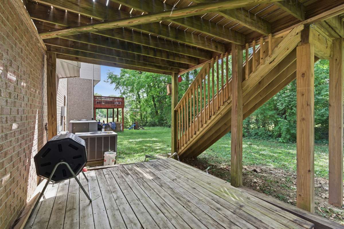 Private two-level back deck offering a comfortable, usable outdoor space—ideal for relaxing, entertaining, or enjoying quiet moments surrounded by mature greenery.