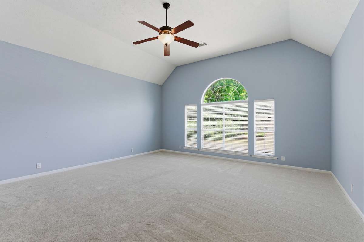 Massive bonus room with vaulted ceilings, oversized arched windows, and abundant natural light. Plush new carpet and flexible layout make this an ideal media room, playroom, or second living space.
