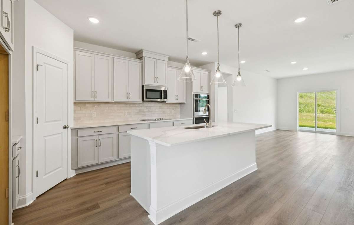 Macon kitchen Picture is for illustrative purposes only. May be of similar home, same floorplan. Options, upgrades, appliance package, colors, selections, designs, may vary.