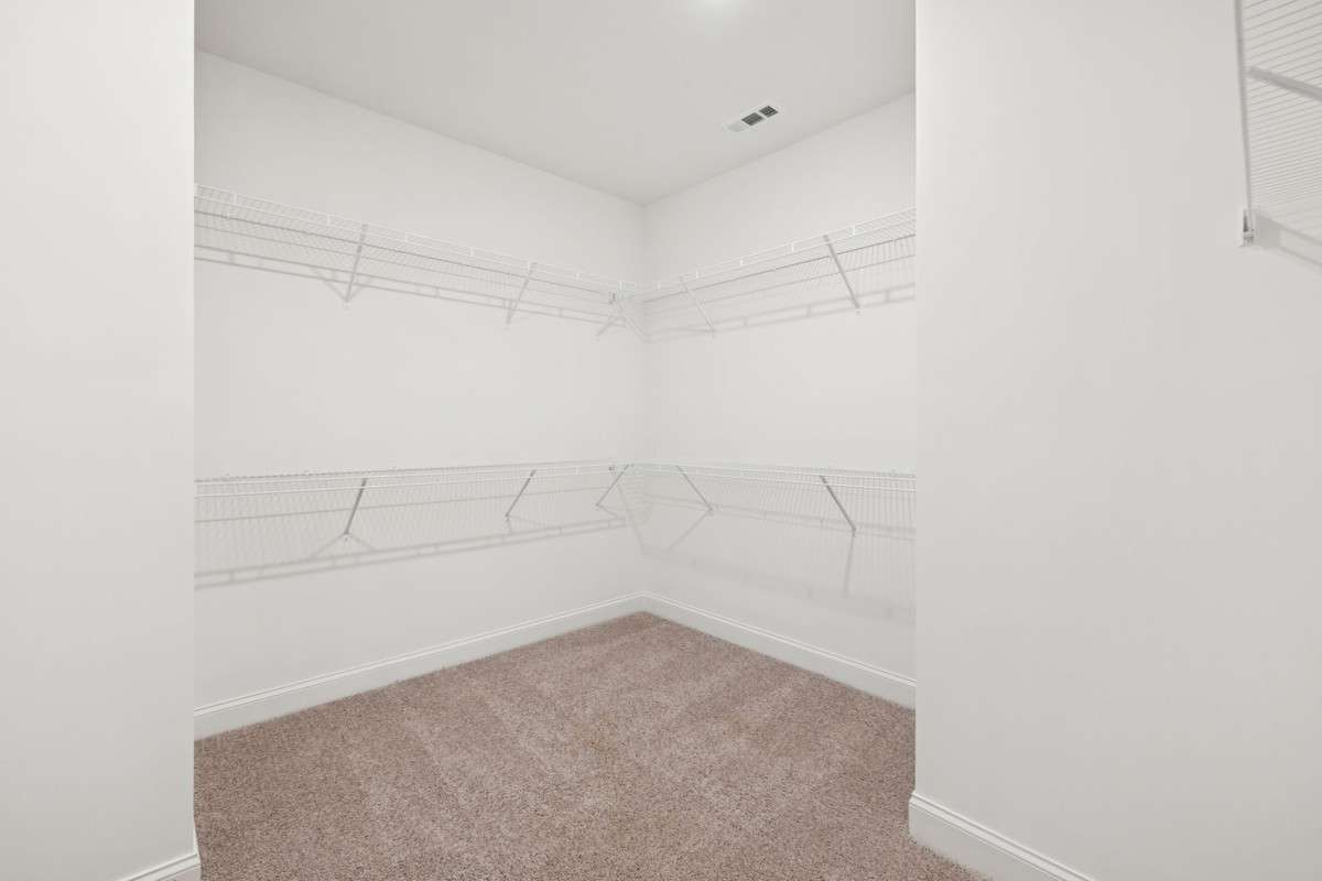 Macon primary walk in closet. Picture is for illustrative purposes only. May be of similar home, same floorplan. Options, upgrades, colors, selections, designs, may vary.