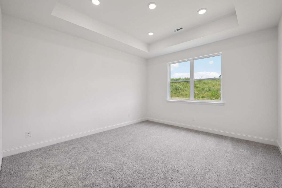 Macon first floor primary suite. Picture is for illustrative purposes only. May be of similar home, same floorplan. Options, upgrades, colors, selections, designs, may vary.