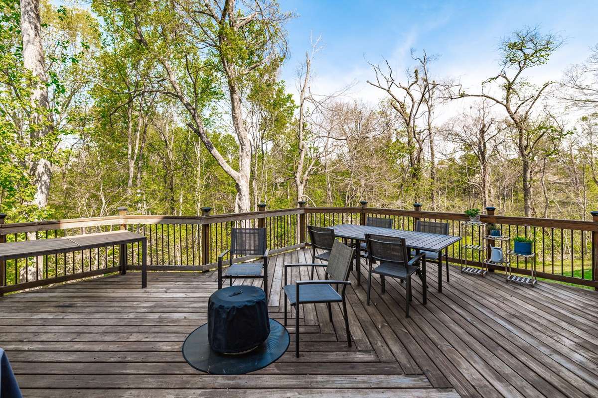 Entertainers deck overlooks the wooded back yard.