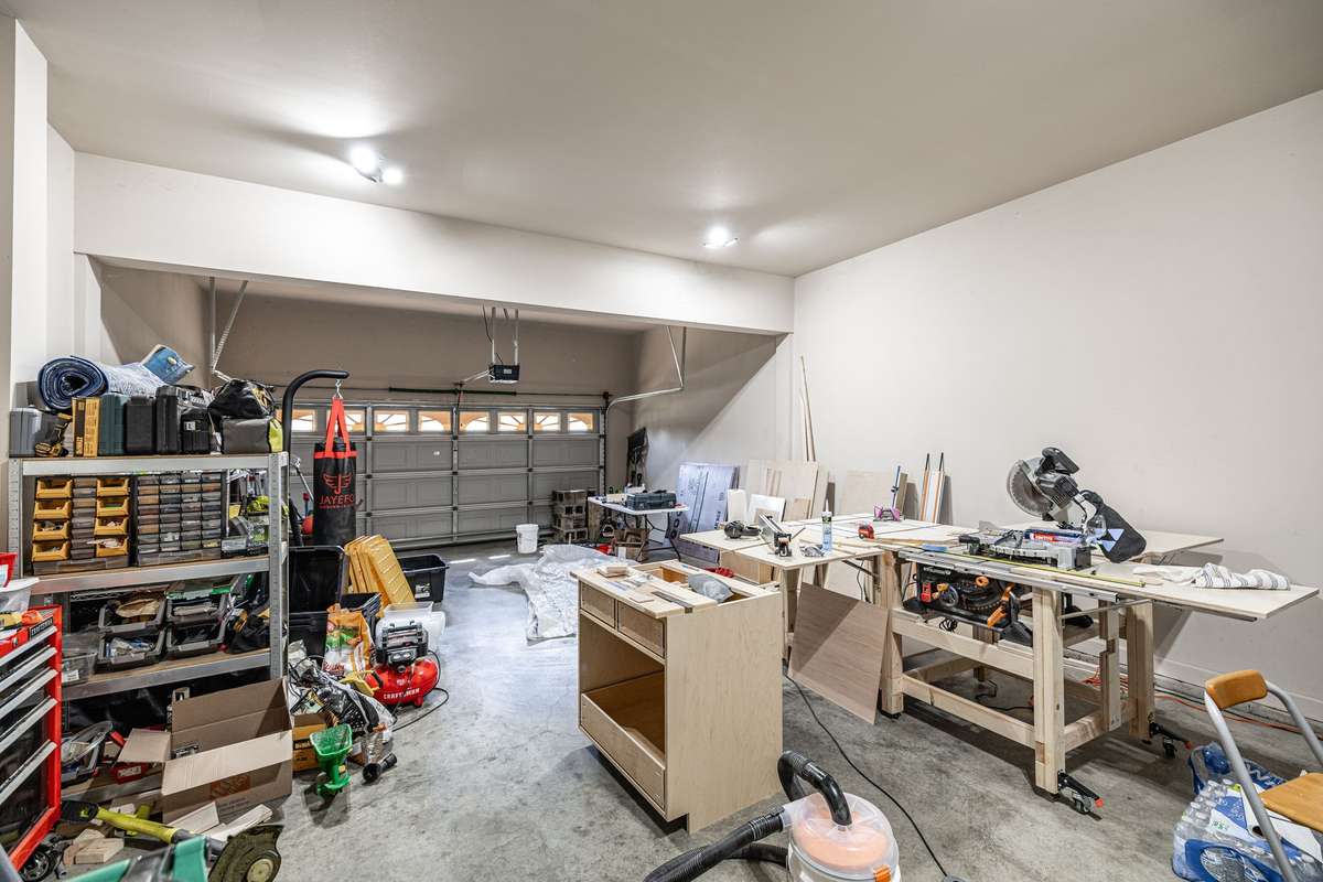 Deep garage (used for projects here) provides plenty of parking space and additional space