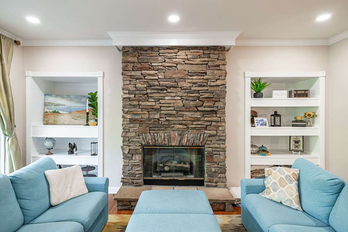 Gorgeous stone veneer and hearth makes a cozy space for gathering