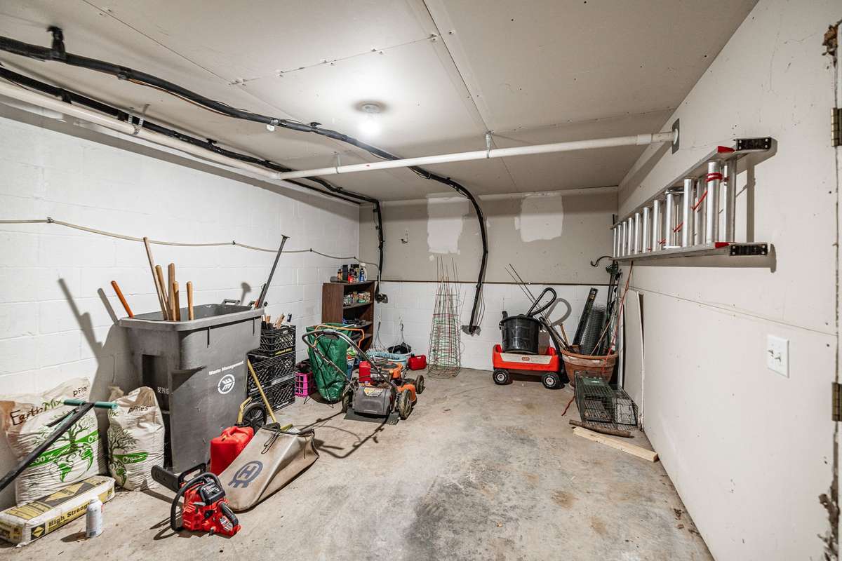 Storm shelter/lawn equipment storage accessible from back exterior of home.