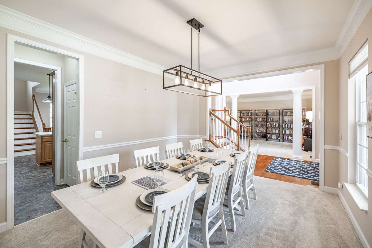 Formal dining room with easy access to kitchen/double pantry, entry way and den.