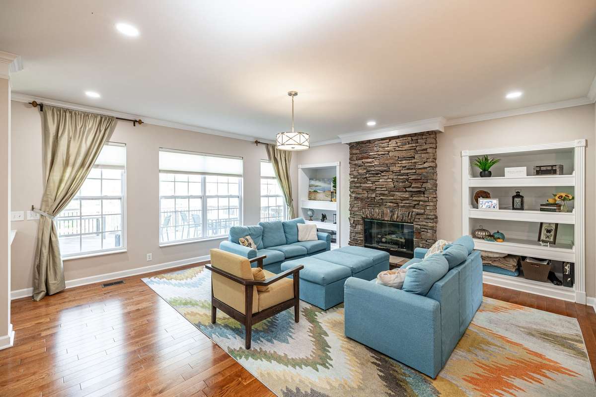 Gathering place / living room with gas fireplace, built in shelving and lots of natural light