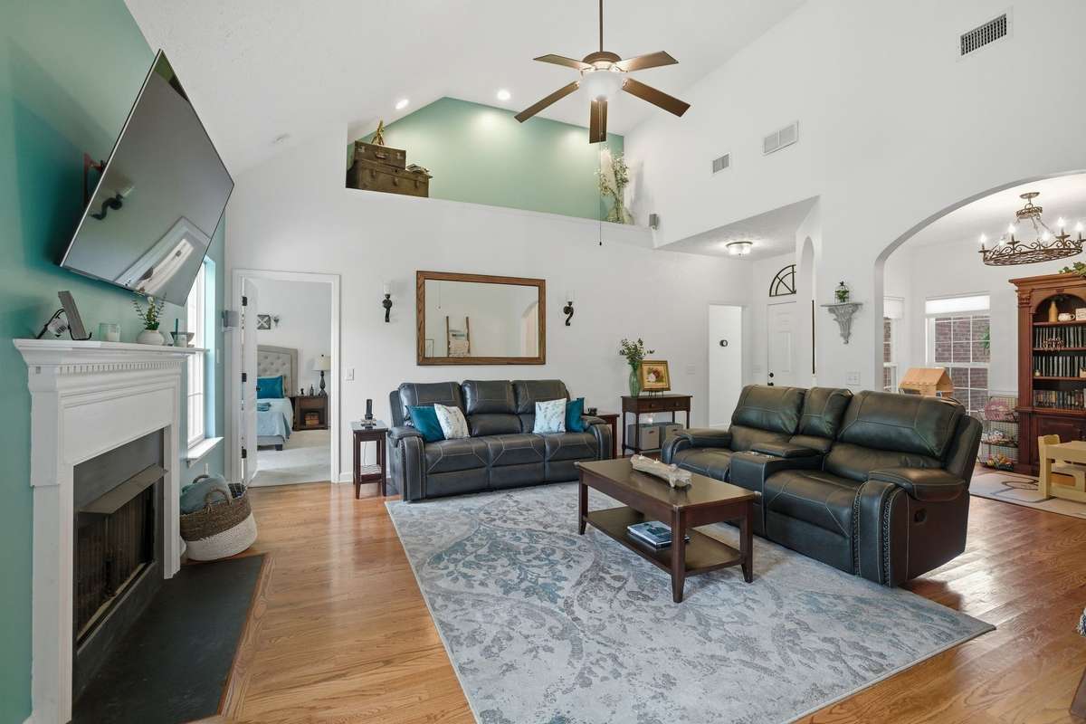The doorway on the top left opens to the primary suite. The doorway on the top right leads to the 2 secondary bedrooms and a full bathroom.