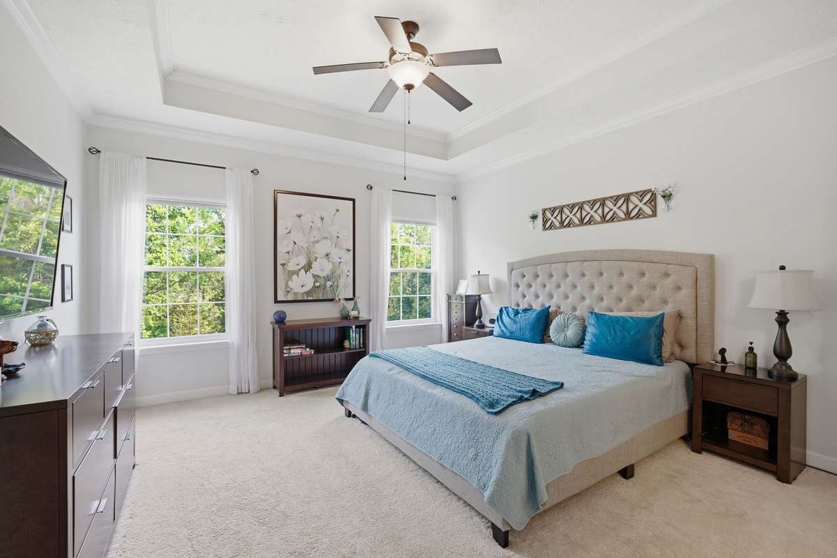 The spacious primary suite, with large windows.